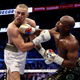 Floyd Mayweather Jr. throws a punch at Conor McGregor during their super-welterweight boxing match on Aug. 26, 2017, at T-Mobile Arena in Las Vegas.